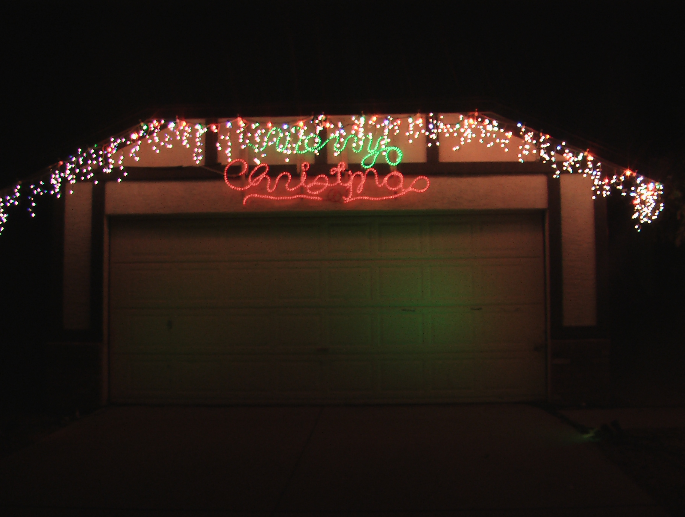 Icicle Lights and Merry Christmas over garage