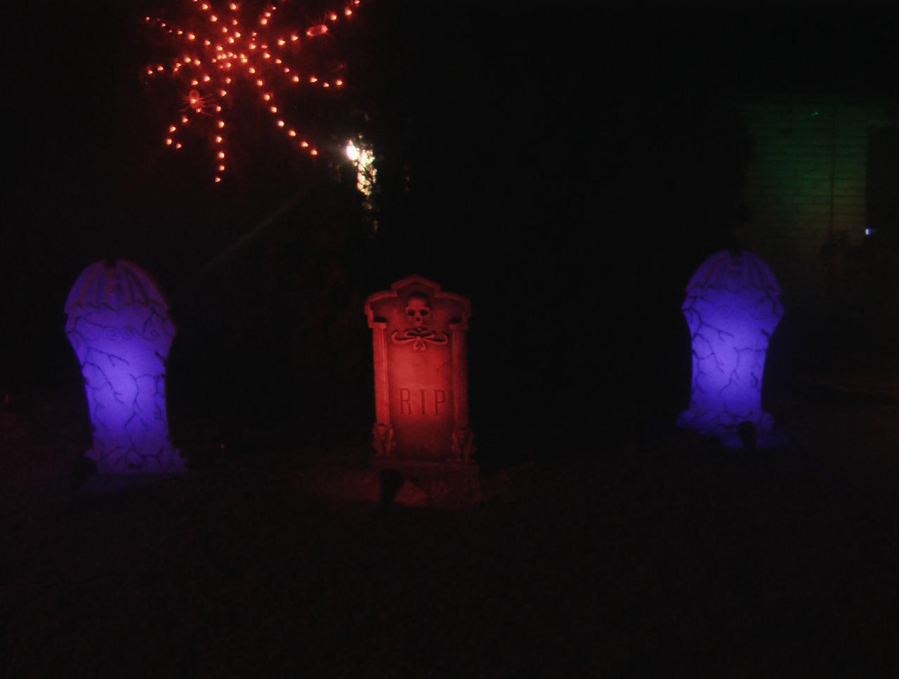 Close up of tombstones and spiderweb